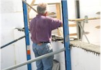 Bob leveling the concrete walls in the garage