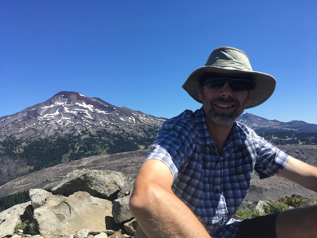 Resting on a climb with a mountain in the background