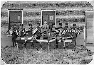 Class of young boys with flags, Albuquerque Indian School